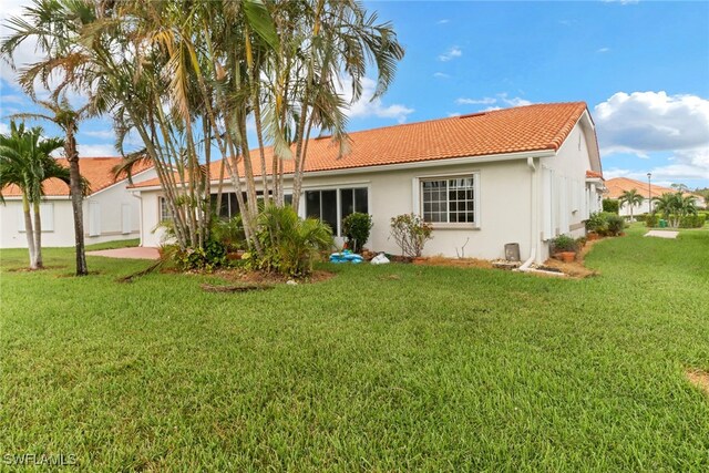 rear view of house with a lawn