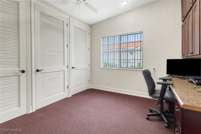 office with ceiling fan and dark colored carpet