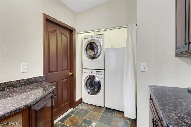 laundry area featuring stacked washer and clothes dryer