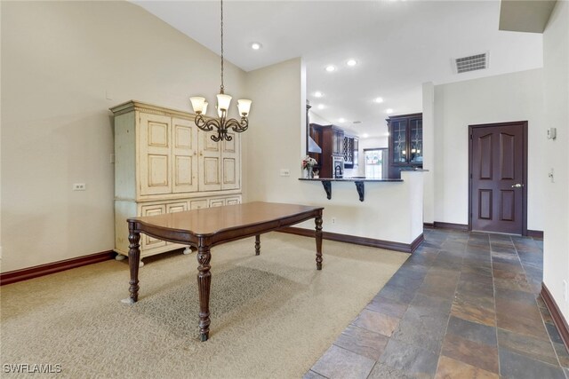 dining room with a high ceiling and an inviting chandelier