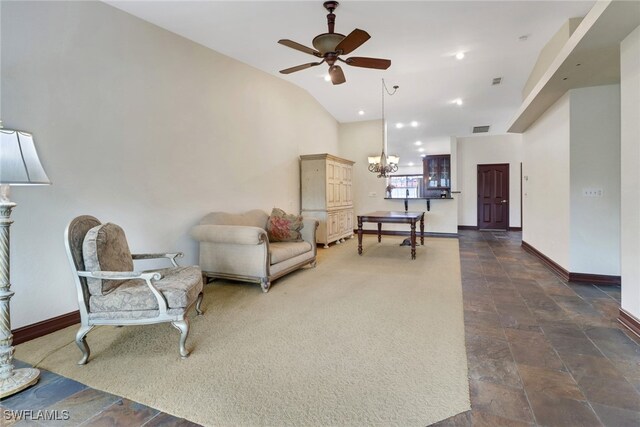 living room with vaulted ceiling and ceiling fan with notable chandelier