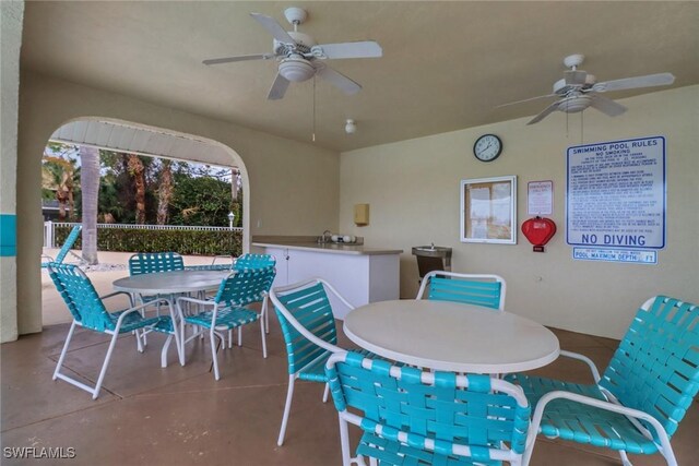 view of patio with a bar and ceiling fan