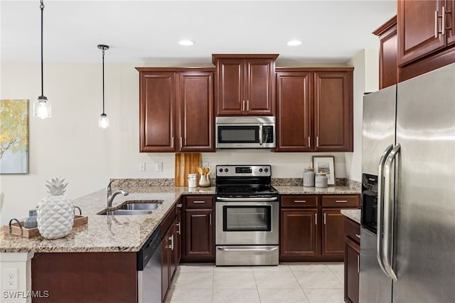 kitchen featuring decorative light fixtures, stainless steel appliances, sink, kitchen peninsula, and light tile patterned floors