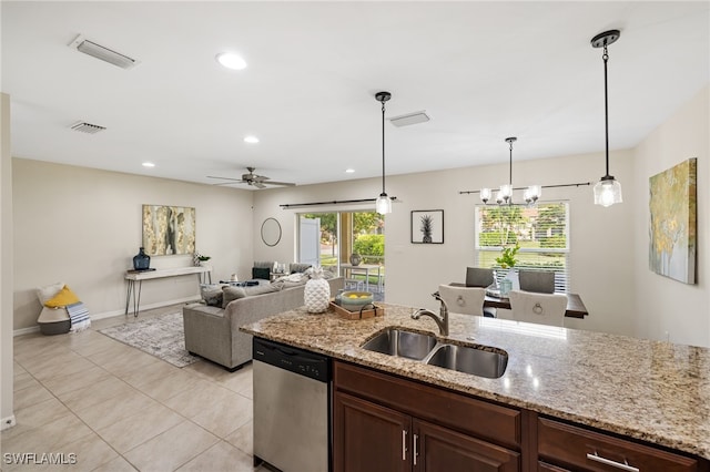 kitchen with dishwasher, sink, hanging light fixtures, light stone countertops, and ceiling fan with notable chandelier