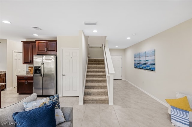 kitchen featuring light tile patterned floors and stainless steel fridge with ice dispenser