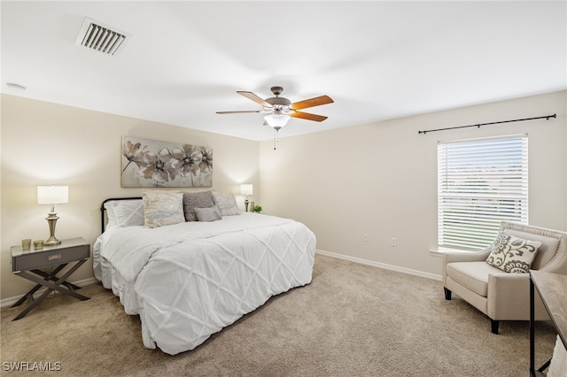 bedroom with ceiling fan and light carpet