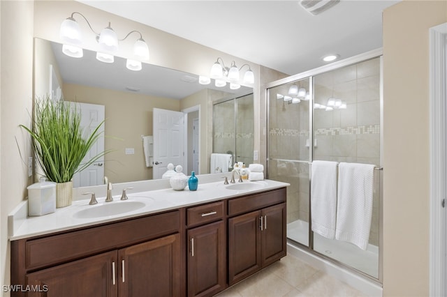 bathroom featuring tile patterned flooring, walk in shower, and vanity