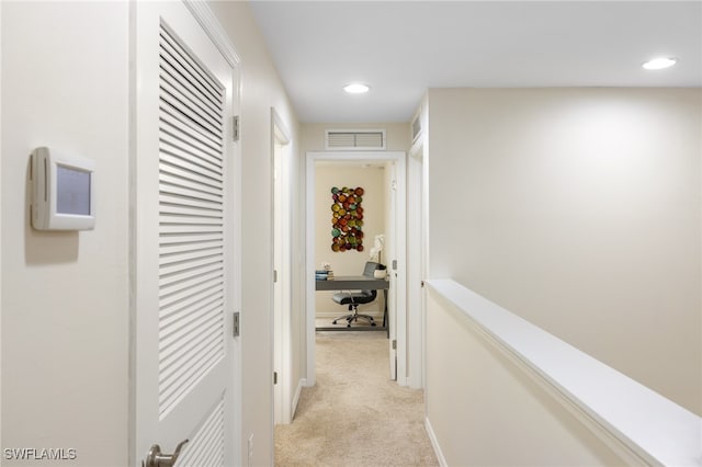 hallway with light colored carpet