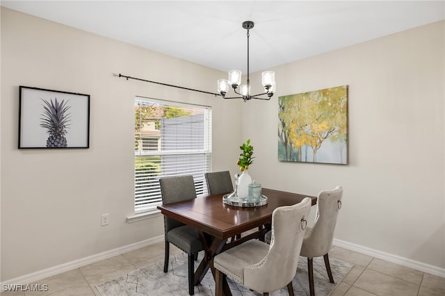 tiled dining room with a chandelier