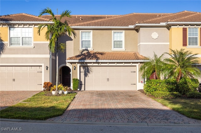 mediterranean / spanish-style house with a garage