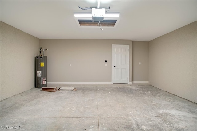 garage with a garage door opener and electric water heater