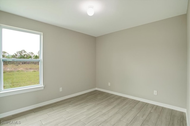 unfurnished room with light hardwood / wood-style flooring