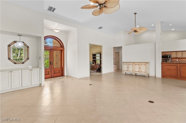 tiled entrance foyer featuring high vaulted ceiling and ceiling fan