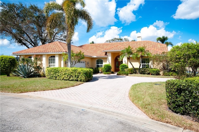 mediterranean / spanish home featuring a front yard