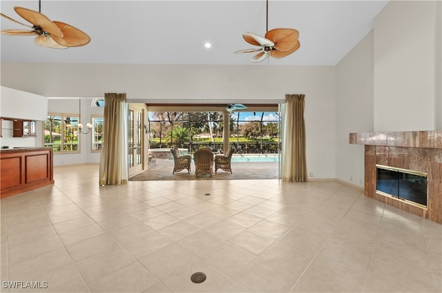 unfurnished living room with a healthy amount of sunlight, light tile patterned floors, and a high end fireplace