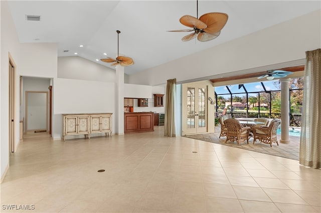 unfurnished living room featuring light tile patterned floors, high vaulted ceiling, and ceiling fan