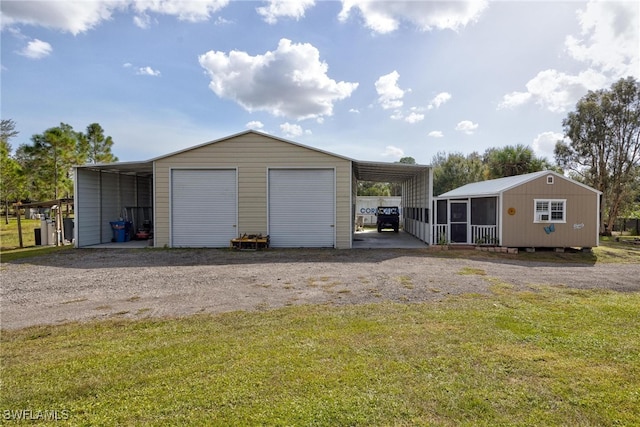 garage with a carport and a lawn