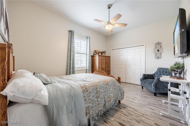 bedroom with light hardwood / wood-style floors, a closet, and ceiling fan