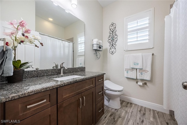 bathroom with vanity, hardwood / wood-style floors, and toilet