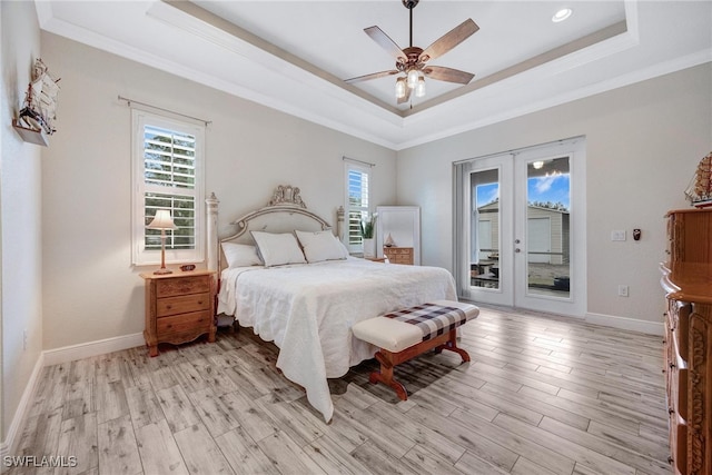 bedroom with access to exterior, crown molding, a raised ceiling, light hardwood / wood-style floors, and ceiling fan