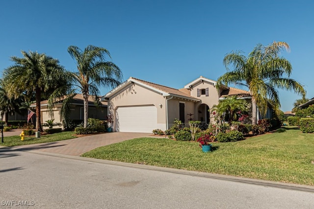 view of front of property with a front yard and a garage