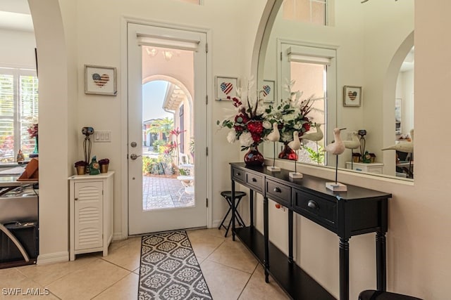 doorway to outside with light tile patterned floors