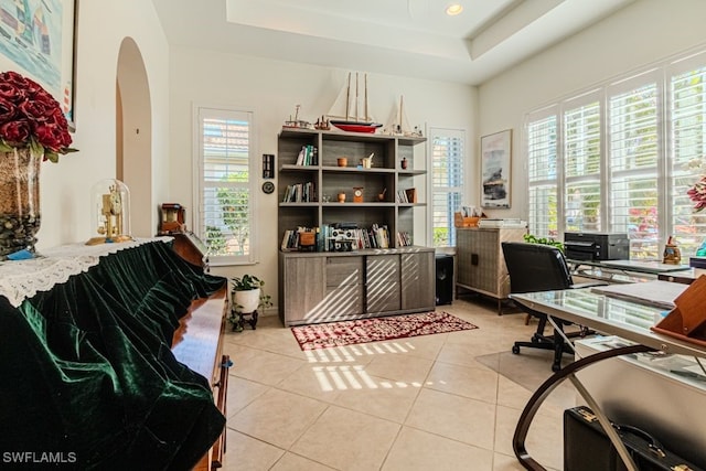 tiled home office with a raised ceiling