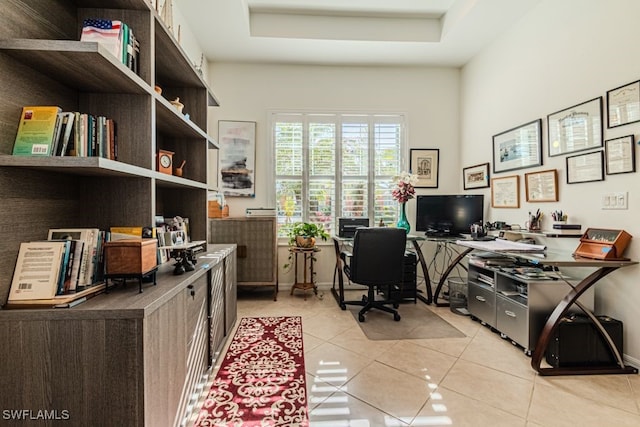 tiled home office with a tray ceiling