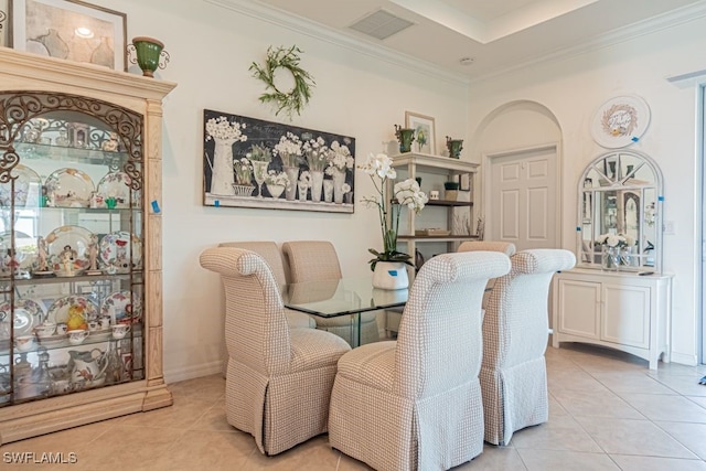 dining area featuring ornamental molding and light tile patterned floors