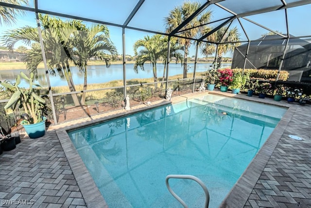 view of pool with a water view and glass enclosure