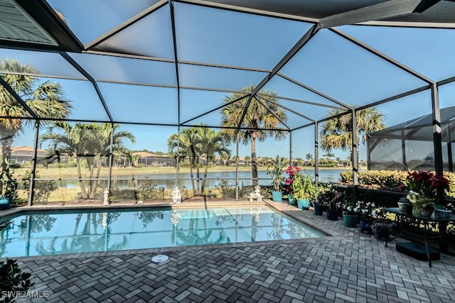 view of swimming pool with a water view, a patio area, and a lanai