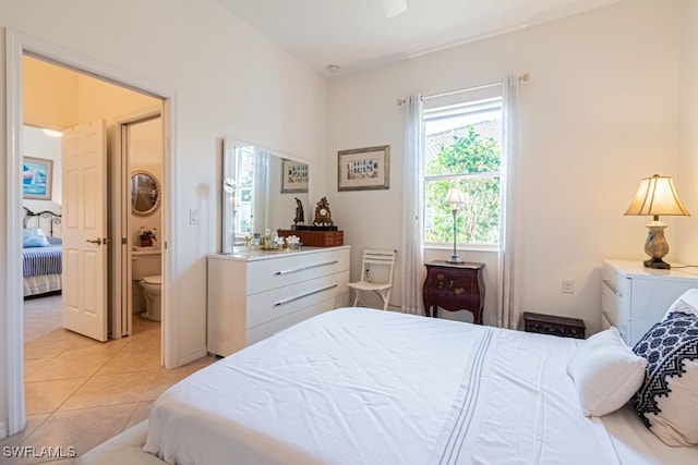 tiled bedroom featuring ensuite bathroom