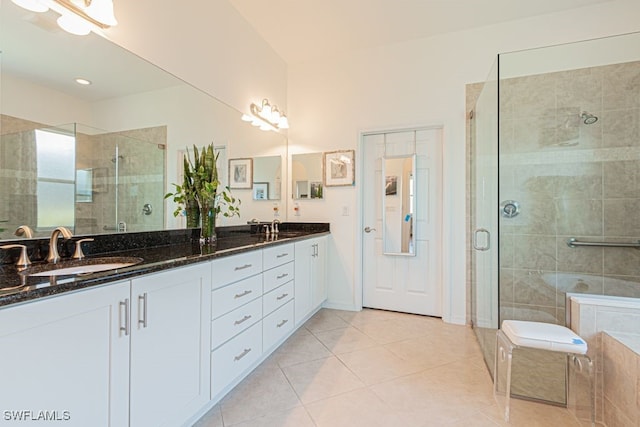 bathroom featuring vanity, plus walk in shower, and tile patterned floors