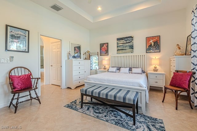 tiled bedroom with a raised ceiling