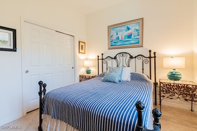 bedroom with a closet and light tile patterned floors