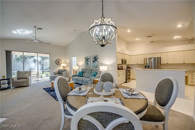 carpeted dining room featuring ceiling fan with notable chandelier and high vaulted ceiling