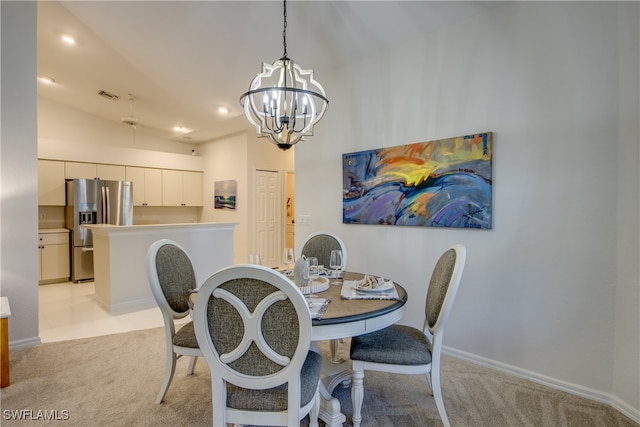 dining space with lofted ceiling, a notable chandelier, and light carpet