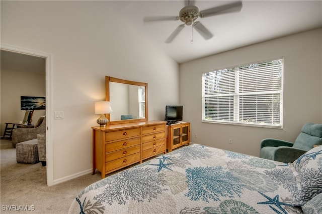 bedroom featuring lofted ceiling, light colored carpet, and ceiling fan