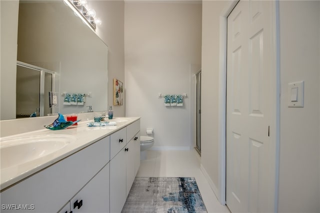 bathroom featuring vanity, tile patterned floors, toilet, and walk in shower