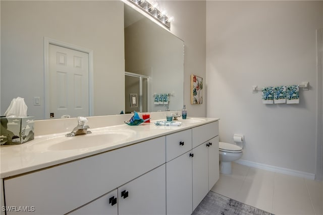 bathroom featuring toilet, a shower with shower door, vanity, and tile patterned flooring