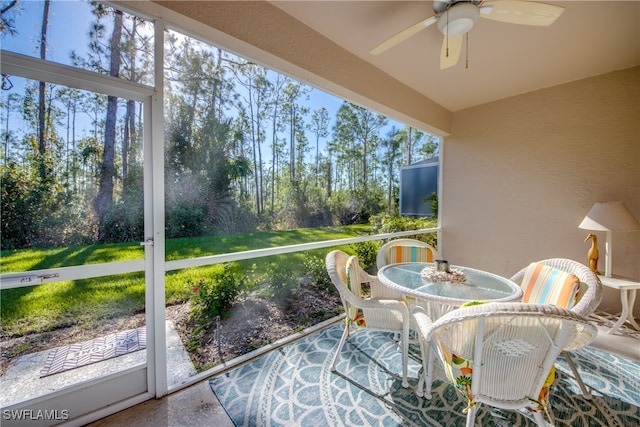 sunroom / solarium featuring ceiling fan and plenty of natural light