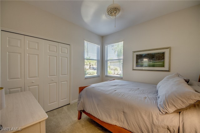 carpeted bedroom featuring a closet and ceiling fan