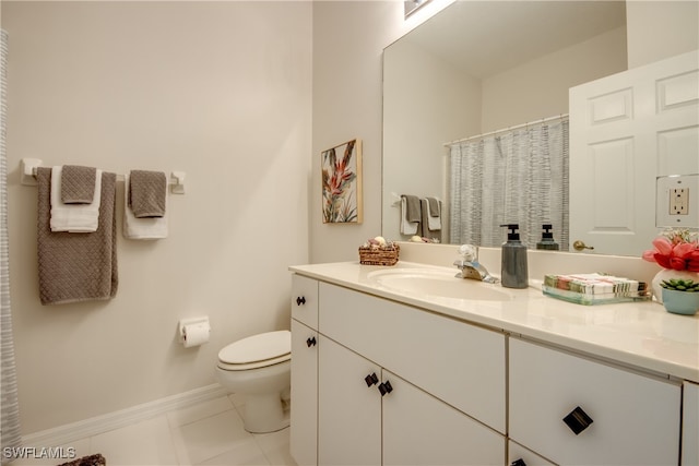 bathroom featuring vanity, toilet, and tile patterned flooring