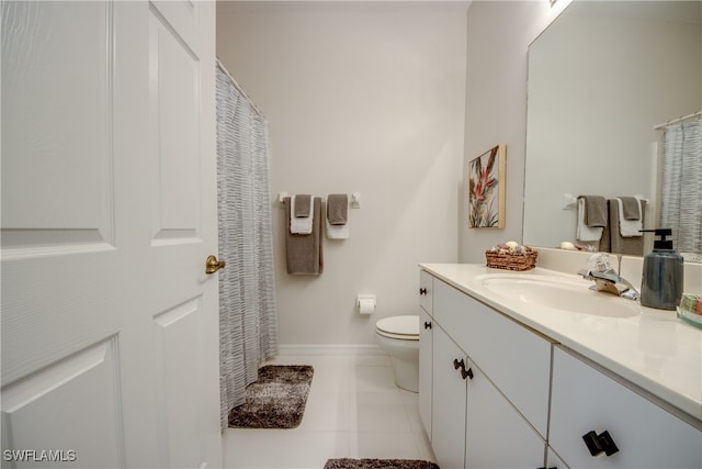 bathroom with vanity, toilet, and tile patterned floors