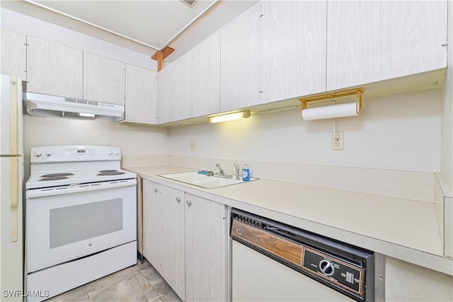 kitchen with white cabinets, sink, light tile patterned floors, and white appliances