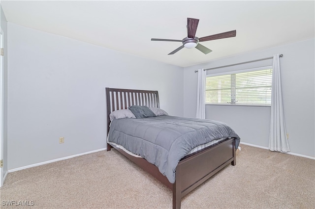 bedroom with ceiling fan and light carpet