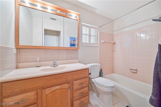 full bathroom featuring vanity, tile patterned flooring, decorative backsplash, tiled shower / bath combo, and toilet