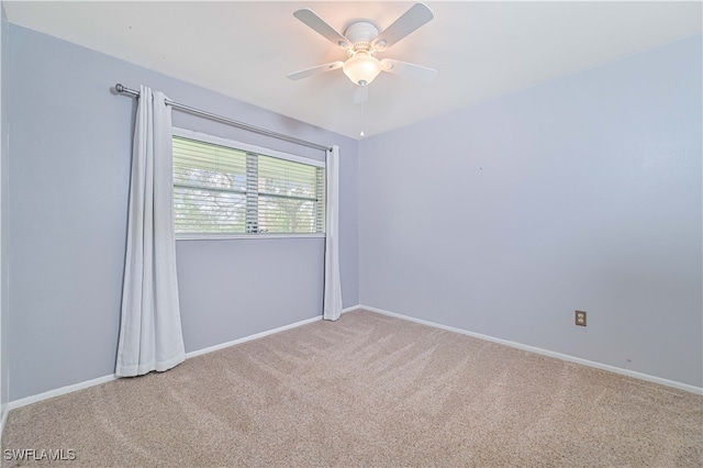 spare room featuring carpet and ceiling fan