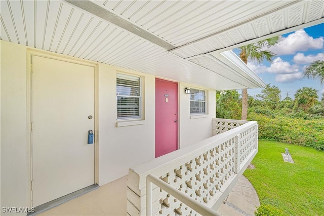 view of exterior entry with a yard