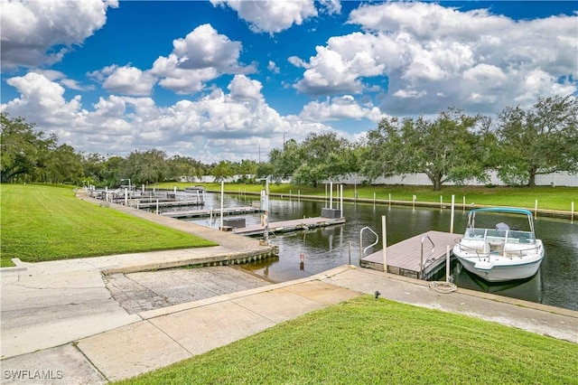 view of dock featuring a lawn and a water view